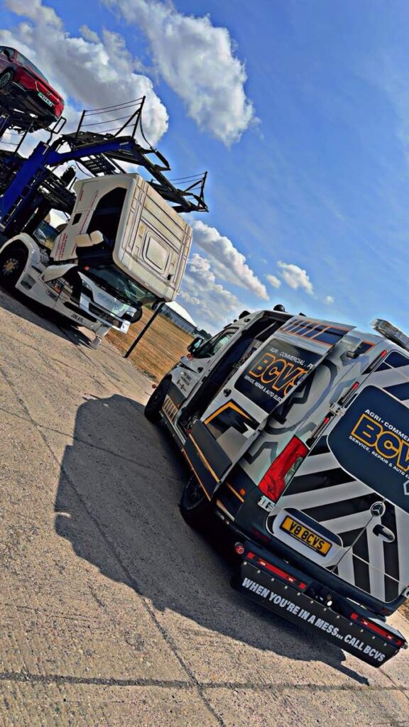 BCVS van parked alongside a loaded car transporter during a repair
