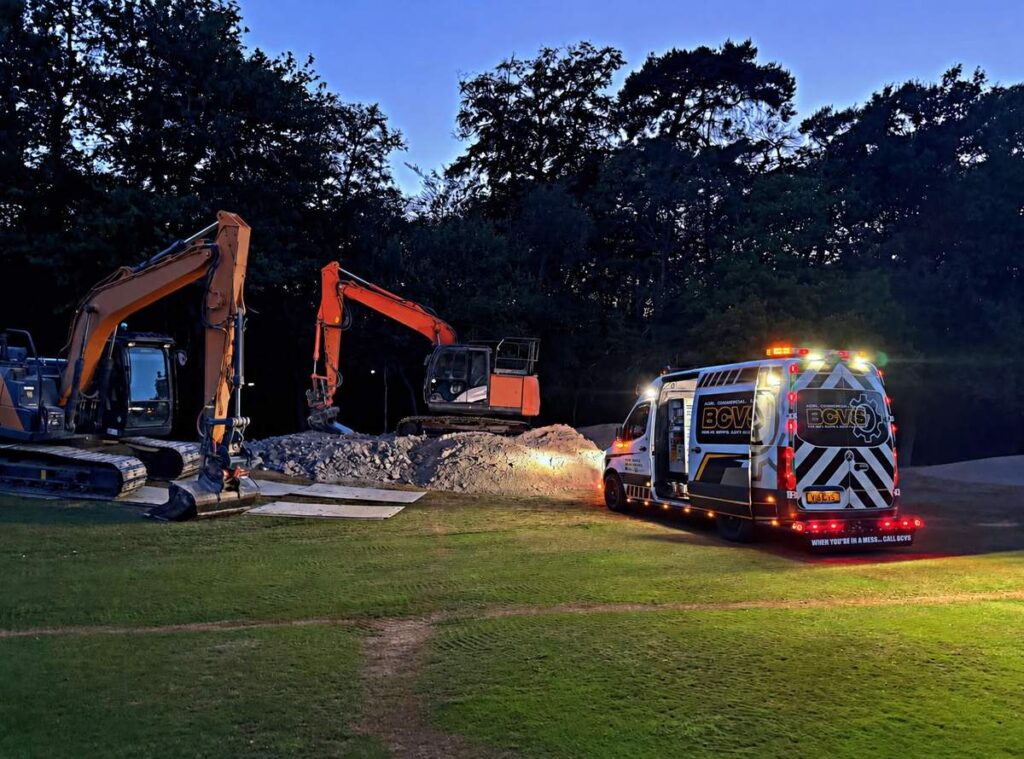 Two tracked excavators on a construction site at dusk with the BCVS service van alongside