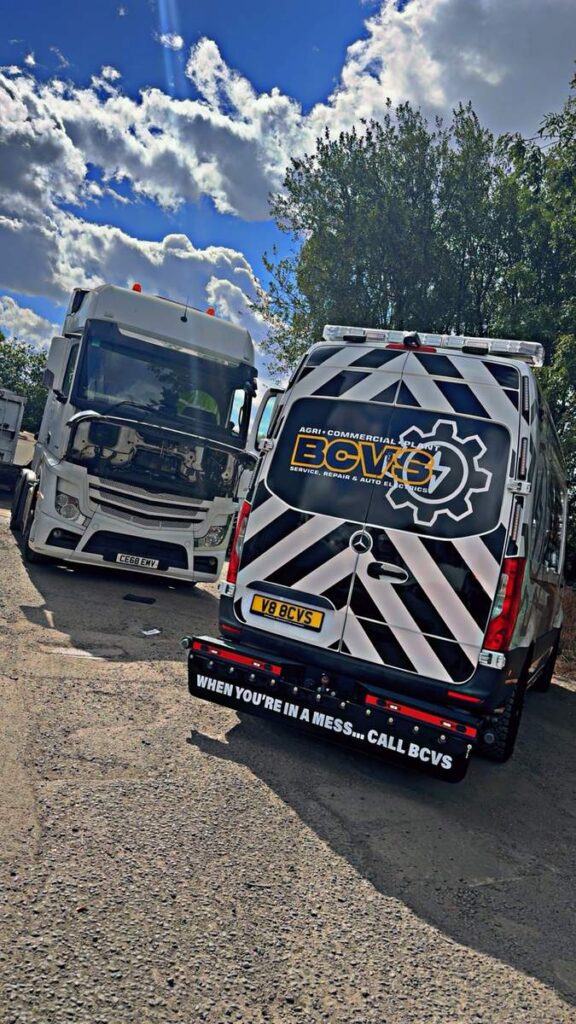 BCVS van with rear chevrons and beacons parked behind an HGV on a dual carriageway