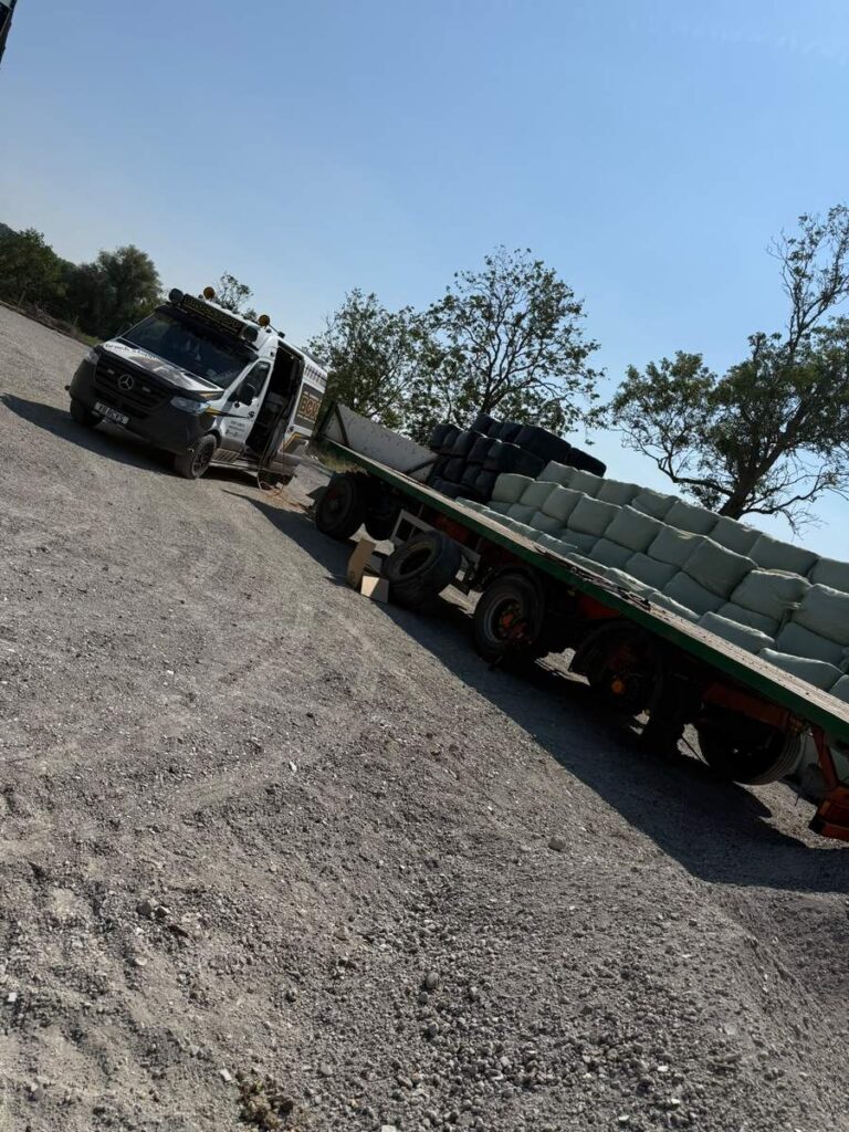 Loaded low-loader trailer on a gravel track with the BCVS van in attendance