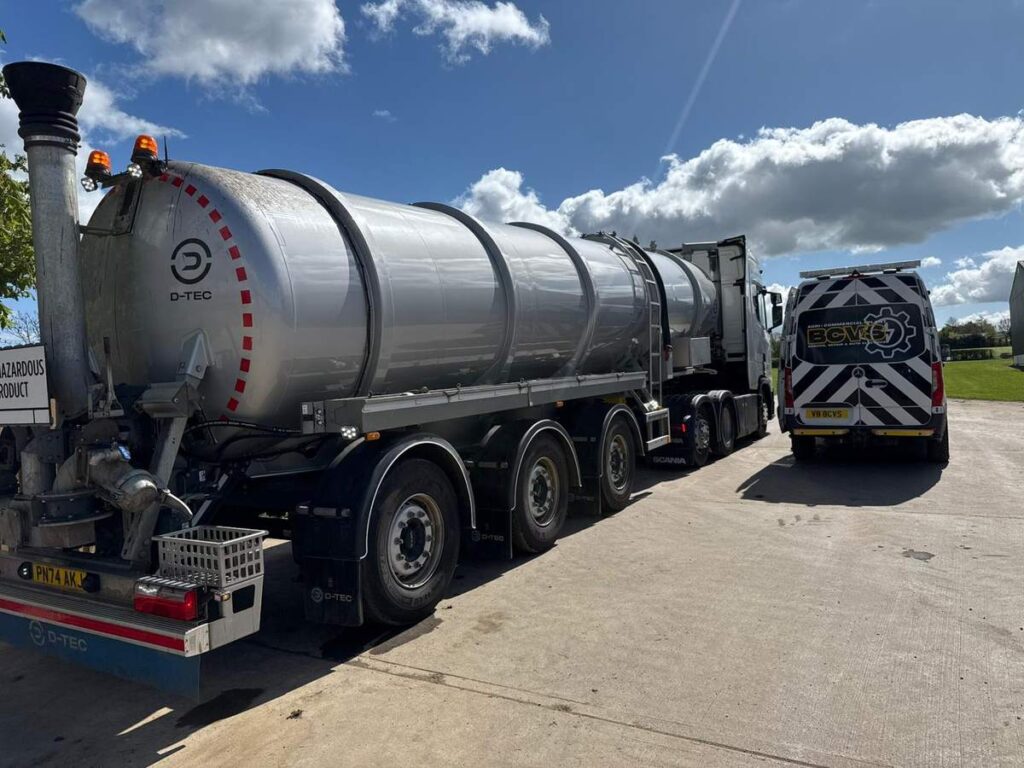 Stainless steel road tanker parked on a yard with the BCVS van behind it