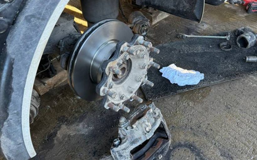 Trailer wheel hub and brake assembly stripped down for inspection during a mechanical repair